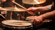 © Nutthaphoom - Drummer playing snare drum with sticks during live performance Generative AI