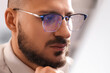 © Pixel-Shot - Handsome male trader in eyeglasses working at office, closeup