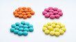 © Rendara Studio - Four groups of colorful round tablets arranged in circular patterns on white