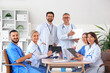 © Pixel-Shot - Team of doctors at table in clinic