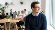 © Png guru - Happy Professional Man With Glasses Smiling While Looking Out A Bright Modern Office Window With Diverse Colleagues Working Collaboratively Behind Him