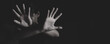 © Tinnakorn - Woman holding up her palm as a symbol of resistance and protection. Concept of women rights, victim support, human trafficking awareness, safety, and freedom.