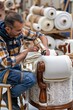 © Nan sarin - AI generator images of furniture craftsman is meticulously applying glue and securing screws to assemble a fabric sofa and chair.