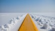 © Unnati - A minimalist photograph of a yellow painted road line covered in white snow during winter time