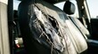 © Tikka MS - Damaged leather car seat interior with large rip.