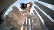 © BlackBridge Media - Woman in Flowing White Dress Among Concrete Columns