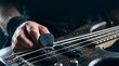 © Predicted - Musician playing electric bass guitar with pick creating water splashes