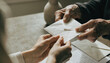 © adaptable_ Lark98A1 - Elder hand letter envelope family nostalgia connection support table communication female male elderly adult relationship emotion closeup paper message vintage memory sharing gratitude trust caring