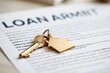 © The Little Hut - Close-up of a house key with a golden house-shaped charm resting on a loan agreement document