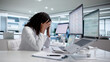© Andrey Popov - Tired Healthcare Worker Uses Laptop At Hospital, Feeling Stressed
