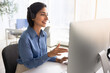 © fizkes - Technical support operator in headset talks with client, consulting online, explaining, provide assistance sits at workplace desk with computer monitor. Call center operations, remote helpline service