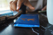 © Towfiqu Barbhuiya  - Hand touching a boarding pass at a travel desk