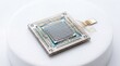 © MD. MAHRUF ZAMAN - A detailed microchip processor mounted on a white circular base with delicate gold connectors.