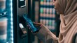 © Yassine - Muslim woman using smartphone for contactless payment at vending machine, digital mobile wallet transaction, modern NFC technology