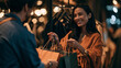 © Justin Eaton - Cheerful Indian customer taking shopping bags with clothes from associate