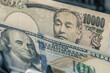 © Rochu_2008 - Japanese Yen versus US Dollar banknotes inside currency counter machine. Japan financial market analysis, forex exchange rate and international banking business background.