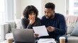 © Eve - Stressed shocked young Black couple reviewing mortgage loan rejection paper document at home, suffering from high interest rates inflation debt bankruptcy financial crisis unpaid bills.