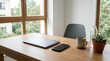 © Tofayel Ahmed - Minimalist office workspace with closed laptop and smartphone on wooden desk, natural light from window, coffee mug and succulent plant, modern interior design, clean aesthetic, home office setup