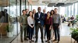 © SammeAkhter - Diverse confident business team in smart casual attire standing together in modern glass office with city skyline, team leader with crossed arms posing proudly for corporate portrait photography