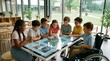 © Vella - Diverse group of happy children using interactive digital table in class