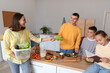 © Pixel-Shot - Happy family cooking in kitchen