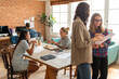 © Rawpixel.com - Diverse team collaborating in a modern office with brick walls.