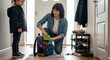 © Maryia - Busy mother packs school backpack while child waits by the door, showing morning rush, parenting pressure and family logistics at home.