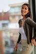 © gzorgz - Portrait of cheerful smiling brunette haired businesswoman standing in a modern office