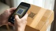 © detiyy - Person scanning QR code on cardboard box with smartphone