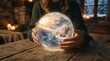 © FryArt - Person holding crystal ball with winter landscape