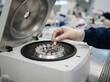 © SimpleDesignStudio - Scientist loading microtubes into a laboratory centrifuge for medical testing and biomedical research