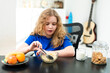 © Volodymyr - Morning nutrition for child. Smiling child eating food. Healthy morning breakfast. Balanced breakfast meal at home. Kid eating cereal at table. Child eating at home indoors. Happy kid eating at home.