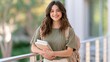 © Alexander LW - Young student smiles warmly while holding books