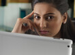 © IndiaPix - Close-up of businesswoman with her hand on her face using digital tablet at desk in office