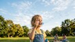 © DSGNCO - Happy child blowing bubbles in sunny park.