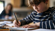 © Marvel’s Nook - Young boy writing in a notebook while studying at a desk, with an adult blurred in the background in a home learning environment.
