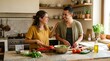 © Marques - Happy couple cooking healthy meal together in a sunny home kitchen