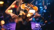 © Fang - Close up of female violinist playing classical music on stage with dramatic lighting, musician performing at live concert, bokeh lights in, artistic musical performance