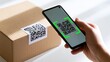 © afdal - Hand holding phone scanning QR code on a cardboard shipping box