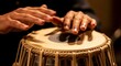© Angavlan - Hands playing tabla instrument with intricate details and rhythmic patterns creating music. Tabla performance showcases Indian musicianship and expertise,
