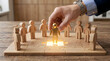 © sohel - Hand placing golden leader figure into corporate puzzle for team building