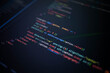© Narong - Close-up of colorful programming source code on a computer screen with shallow depth of field, representing software development, web application coding, user interface engineering, and innovation.