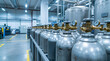 © Kia - Row of industrial gas cylinders in factory interior.