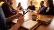 © Danial - Shared Understanding: A group of individuals gathered around a wooden table, engaged in deep conversation, fostering a sense of community and shared purpose with books and coffee cups on the table.
