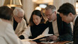 © forenna - Payroll processing specialist at a polished desk in a luxury firm lobby, reviewing holiday bonus disbursement ledgers with an elder senior partner and junior associate leaning in,