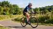 © NoblePix - Woman cycling on a winding road through green countryside on a sunny day