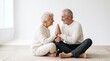 © Syamsuri - Elderly couple pressing palms together in a heartfelt gesture. Senior friends sharing a moment of connection and warmth.