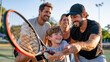 © Maksym Tereshchenko - A family unit of four standing in an empty desolate sports ground at dawn, the parents watching as their child holds a tennis racket mid-swing under coaching instruction from the other parent, the i