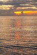 © Alexis - Golden morning sunlight reflecting on ripples of calm ocean surface.