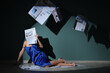 © Pixel-Shot - Young woman in high heels with many newspapers sitting on floor near blue wall